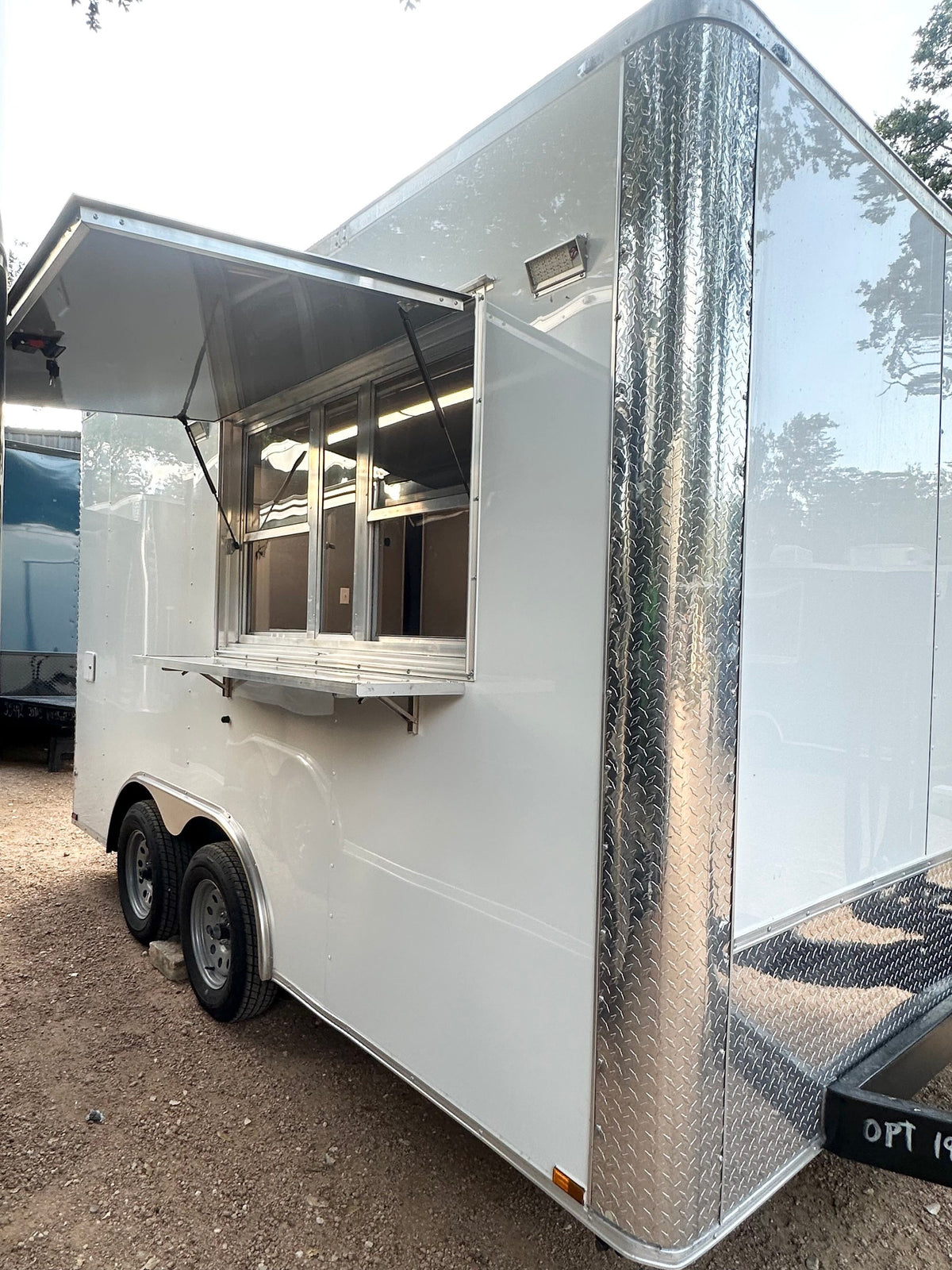 14 FT Burger Trailer by Texas Built Food Trailers, white exterior with diamond plate trim and the concession window open