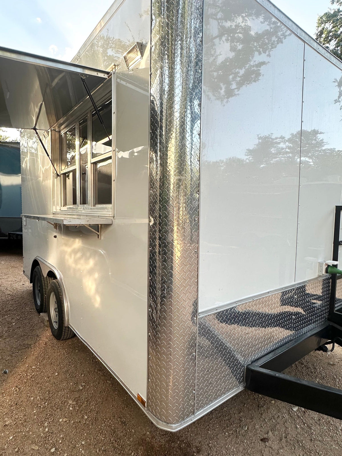 14 FT Burger Trailer front corner view, white with polished diamond plate trim