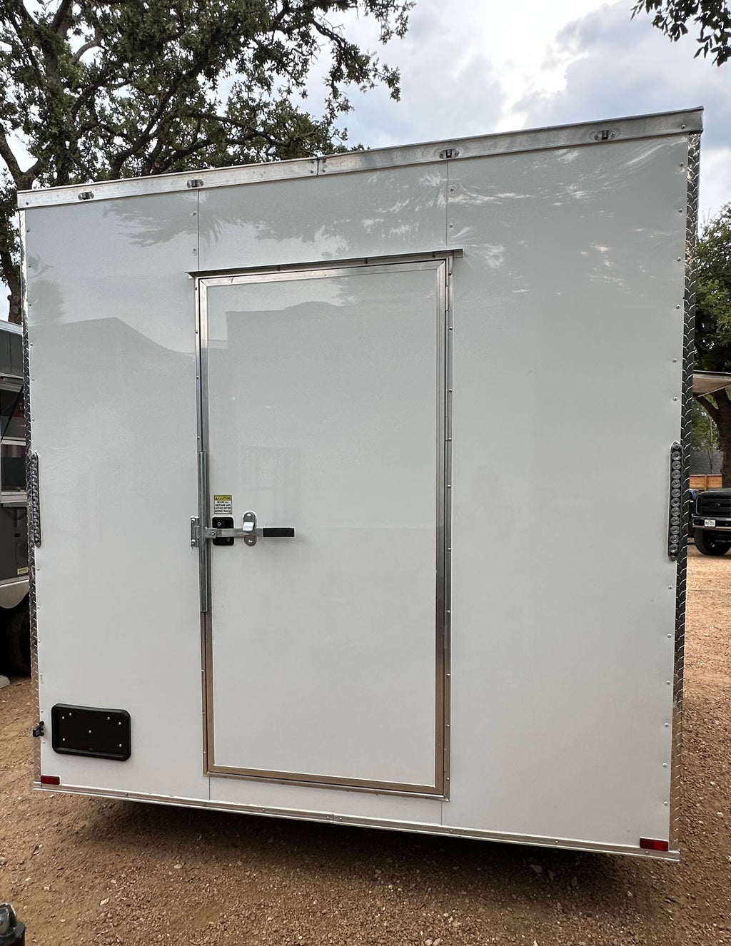 Rear view of the 14 FT Burger Trailer showing the walk-in door and diamond plate corner trim