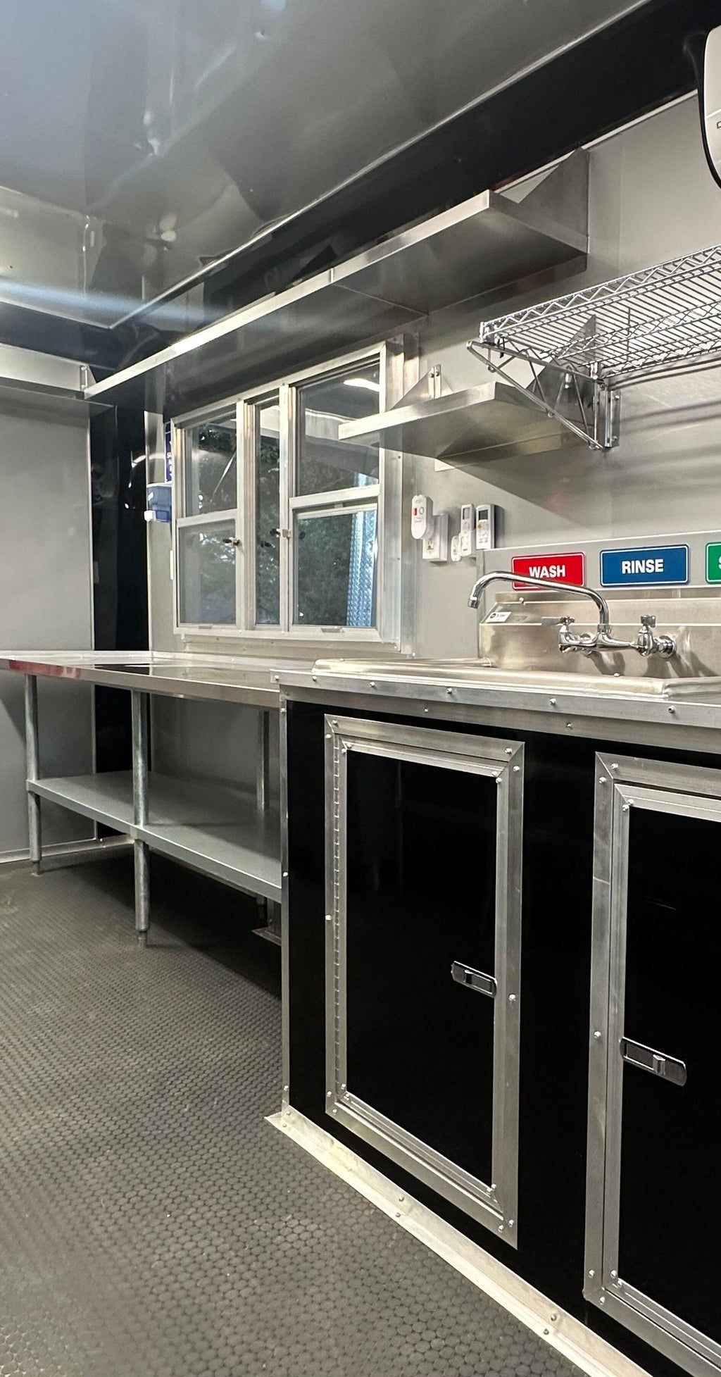 Three-compartment sink and stainless prep tables inside the 14 FT Burger Trailer
