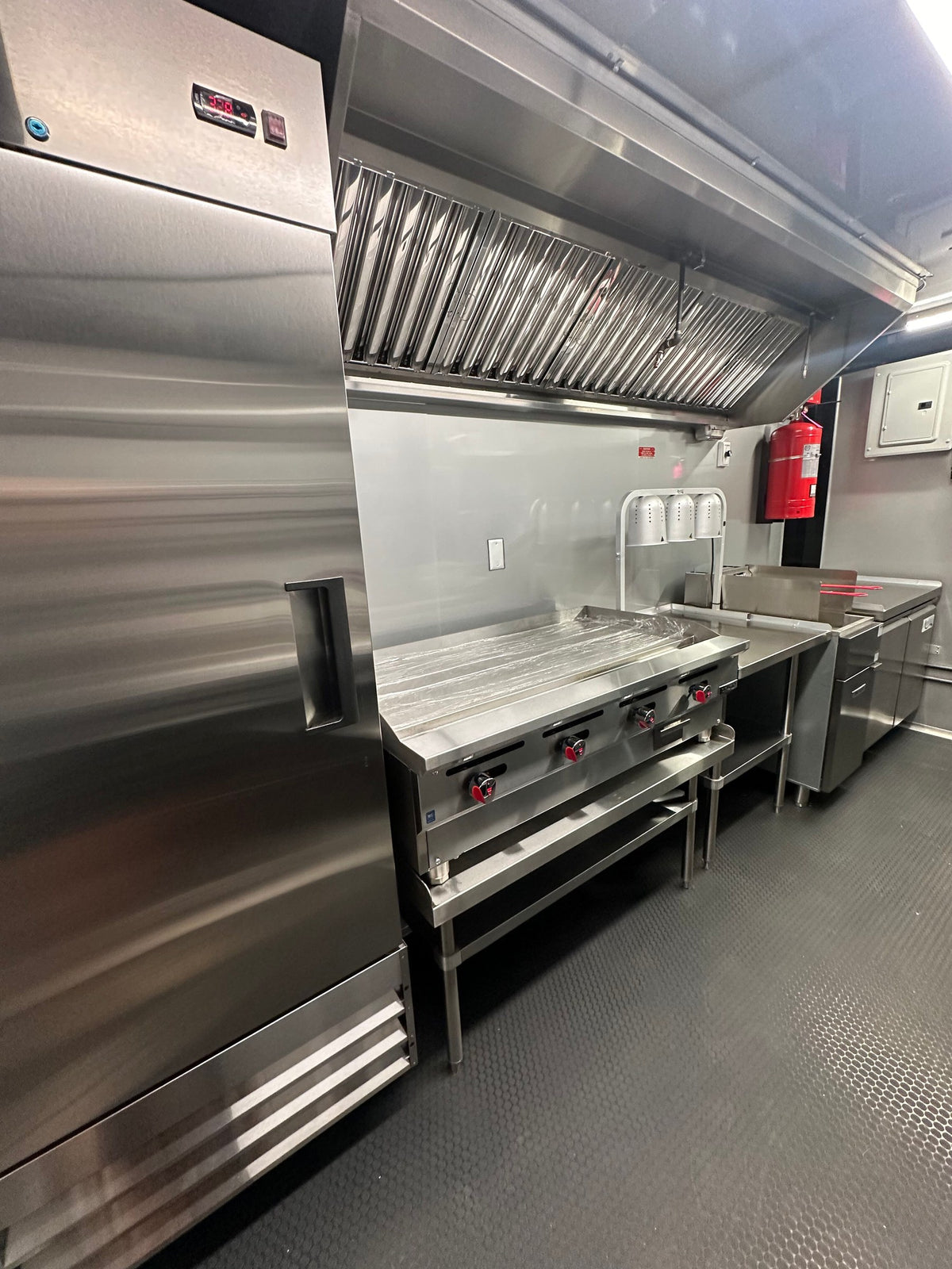 Cook line of the 14 FT Burger Trailer with griddle, 40 lb deep fryer and worktop freezer