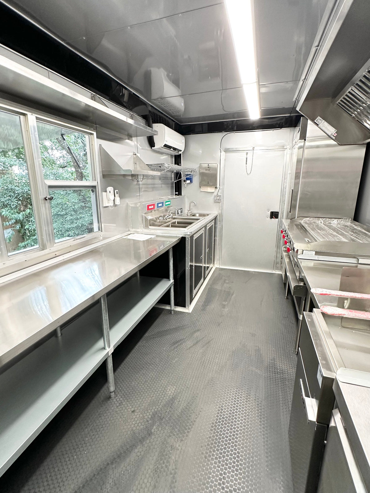 Full length interior view of the 14 FT Burger Trailer from the rear door toward the service window