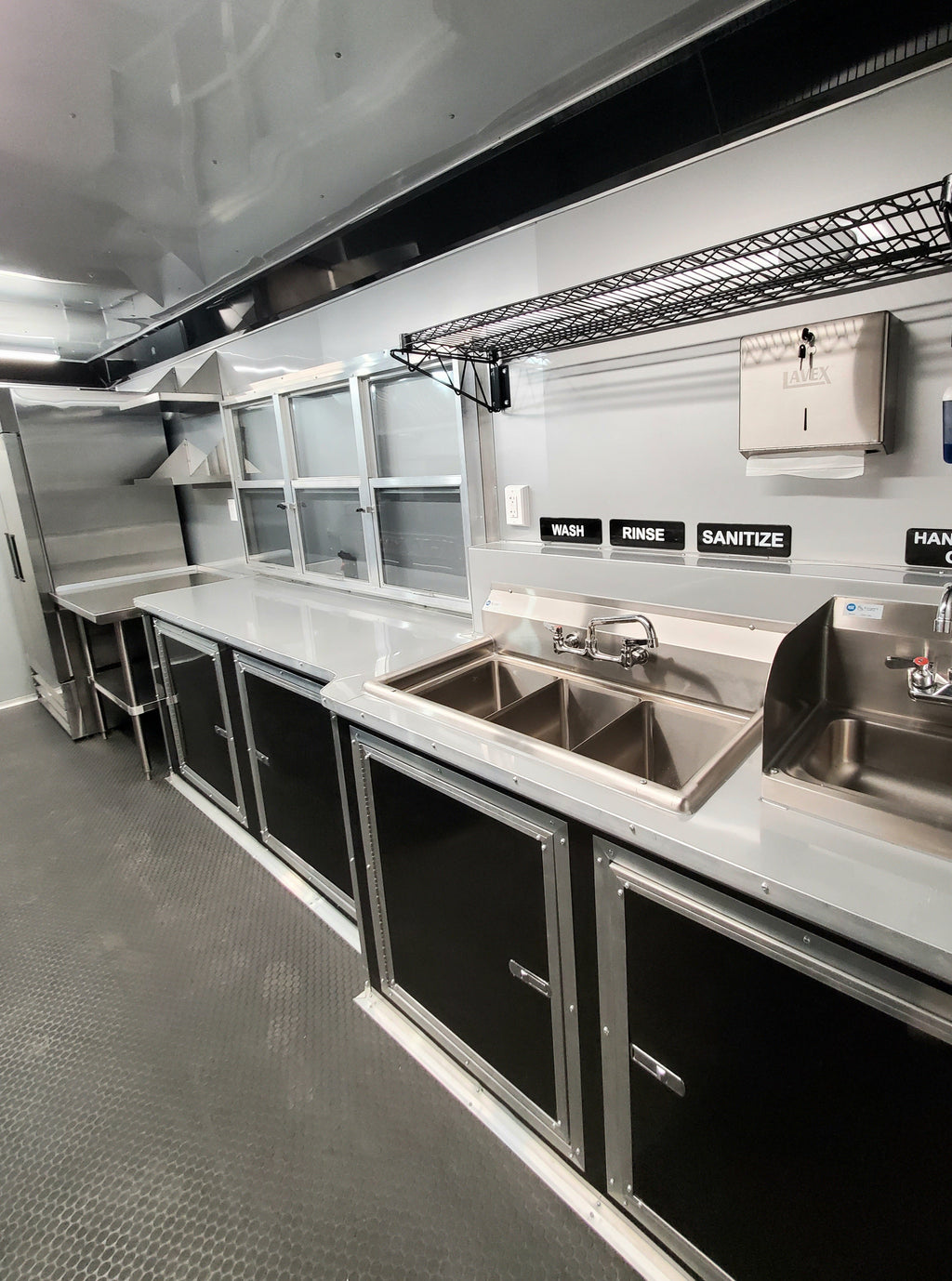 Commercial kitchen with stainless steel counters and sinks