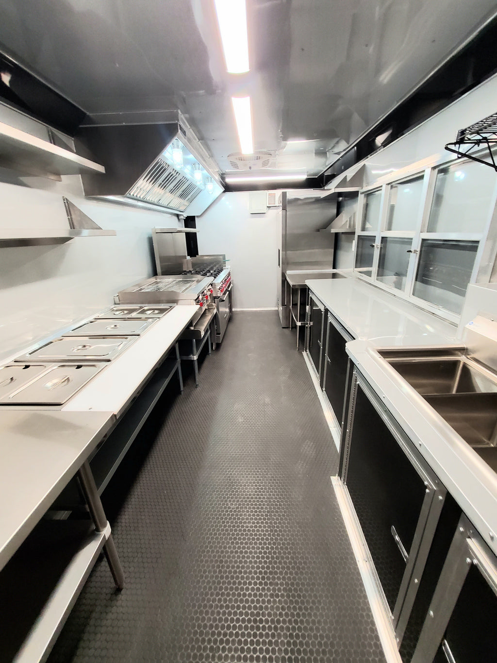 Commercial kitchen interior with stainless steel appliances and counters.