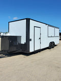 24 FT porch concession trailer in white with black trim, photographed side-on on a concrete lot showing the full length of the body and the side entry door