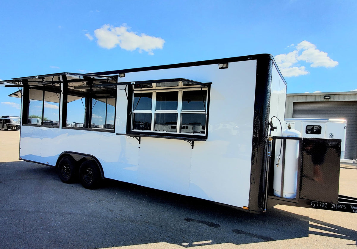 White food truck with black windows on a clear day