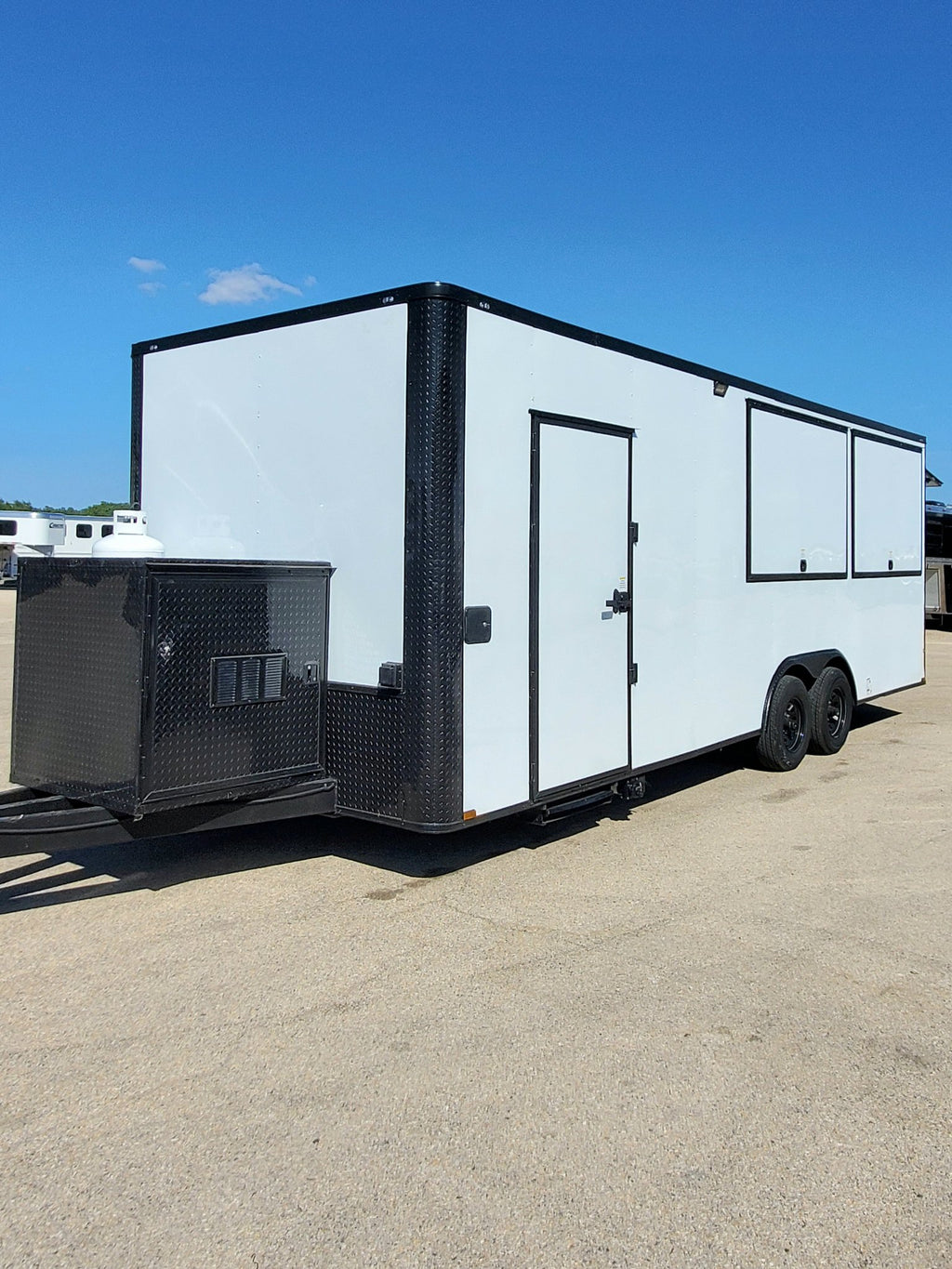 White enclosed trailer with a door on a clear day