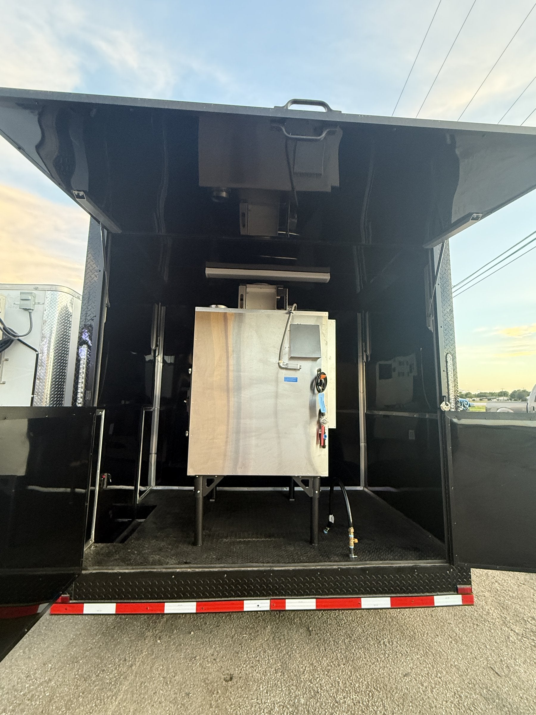 26 FT concession porch trailer, fully loaded, exterior rear open showing utility connections