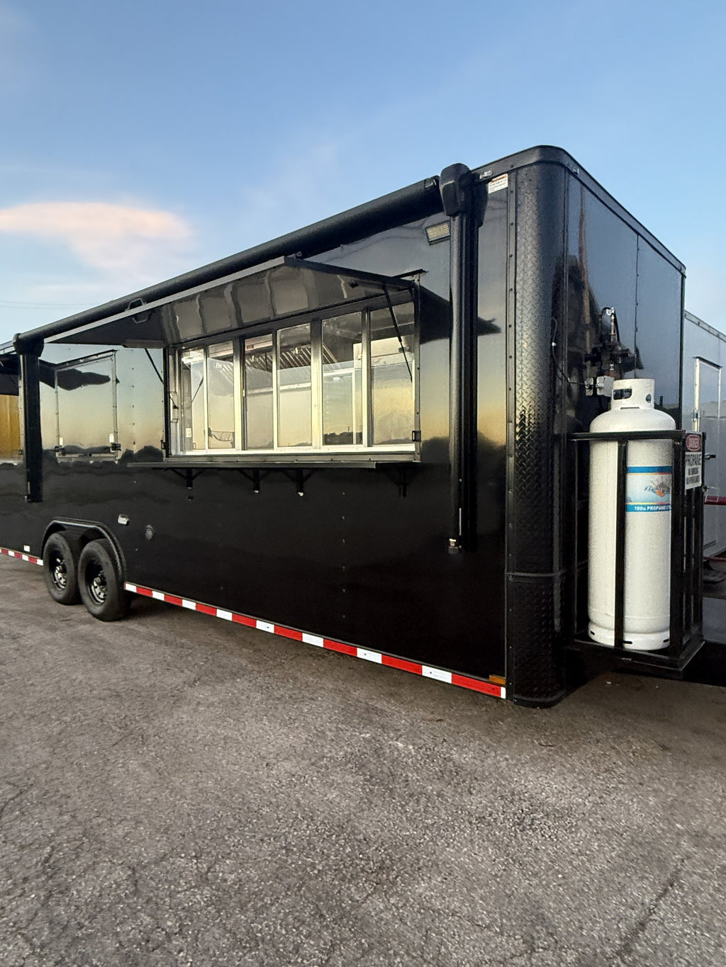 26 FT concession porch trailer, fully loaded, exterior side with awnings raised and propane cage