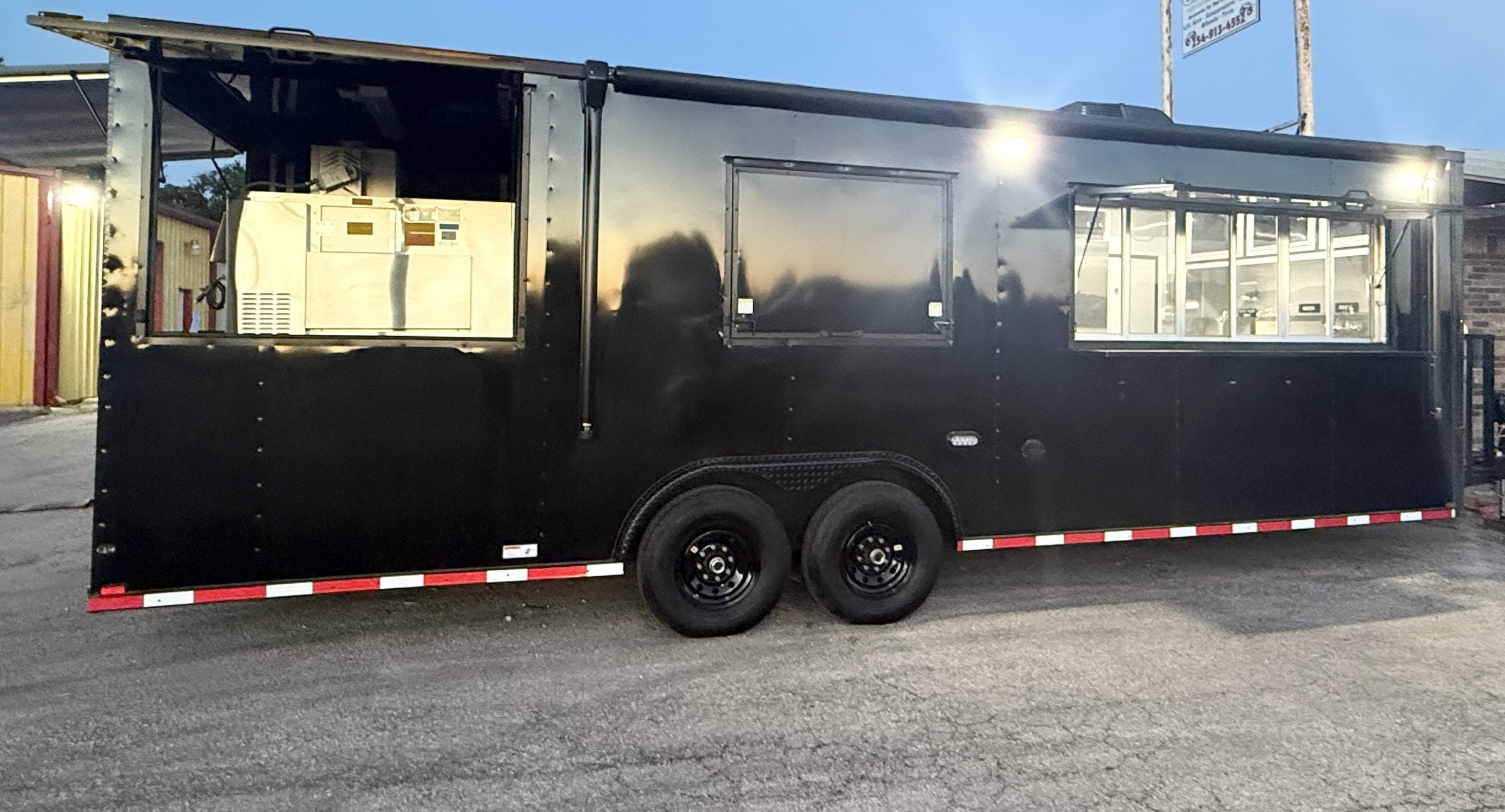 26 FT concession porch trailer, fully loaded, exterior side at dusk
