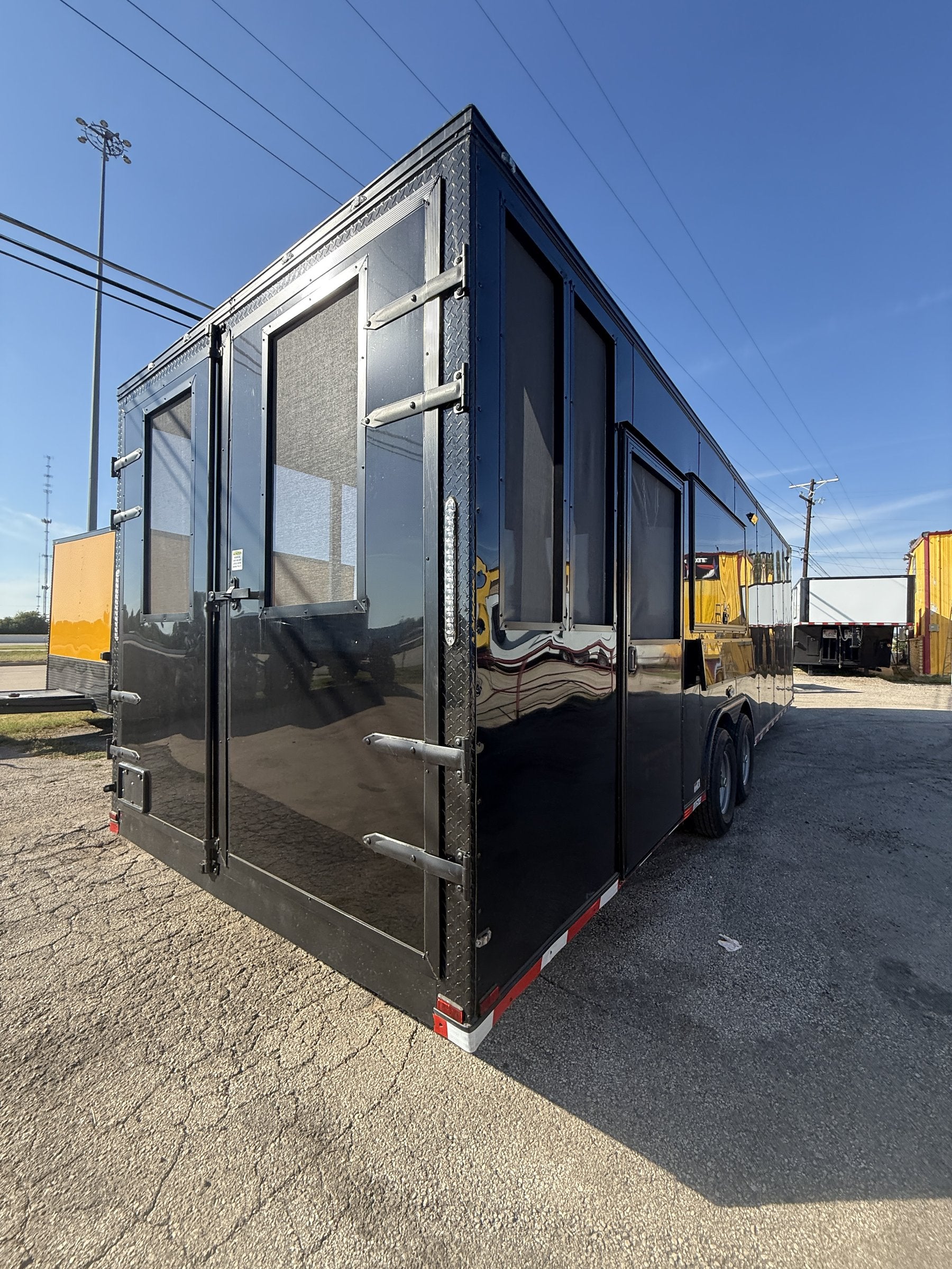 28 FT smoker concession trailer with restroom, exterior three-quarter front with serving windows