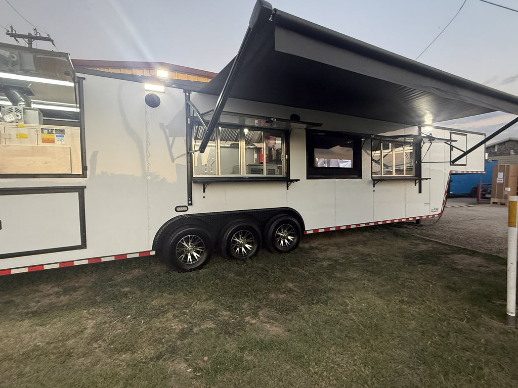 40 FT gooseneck smoker concession trailer, exterior with awning raised over the serving windows