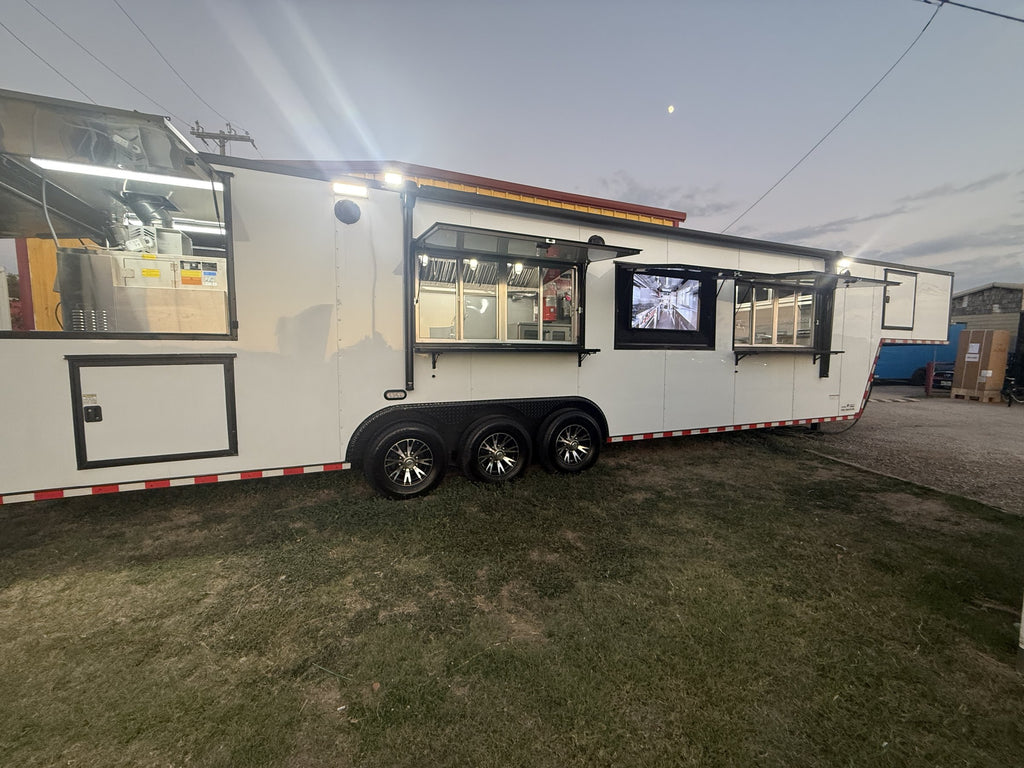 40 FT gooseneck smoker concession trailer, exterior side showing the gooseneck and triple axles