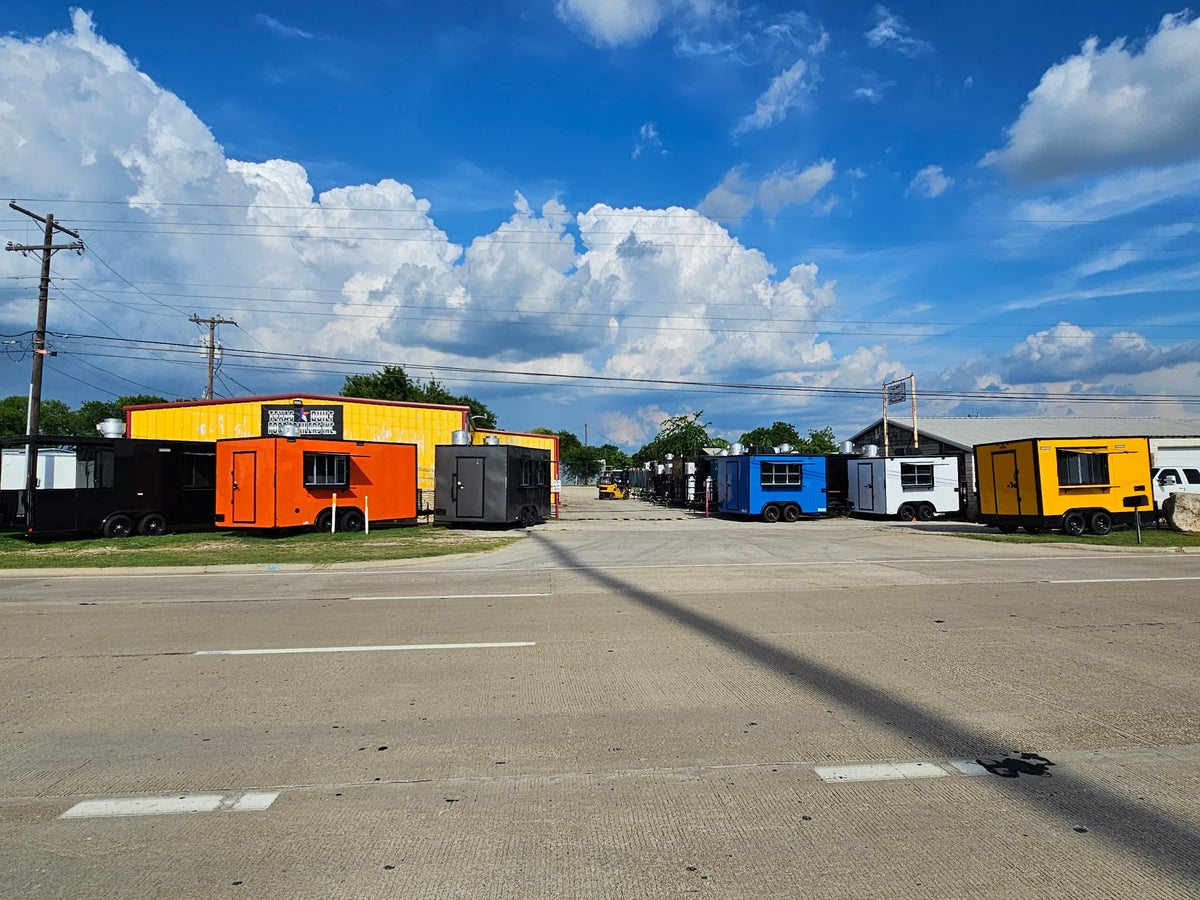Finished food trailers lined up outside the Texas Built shop on the IH 35 service road in Belton, Texas, seen from across the road