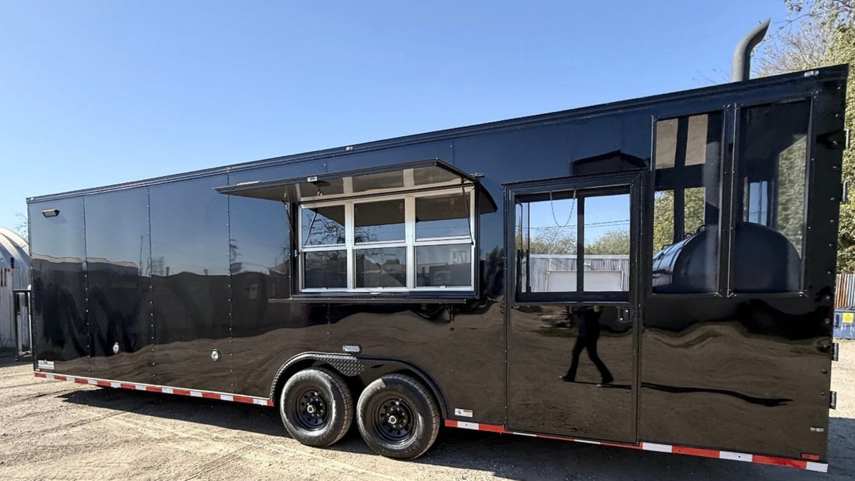 Black concession trailer built in Belton, Texas, parked outdoors with its serving window open