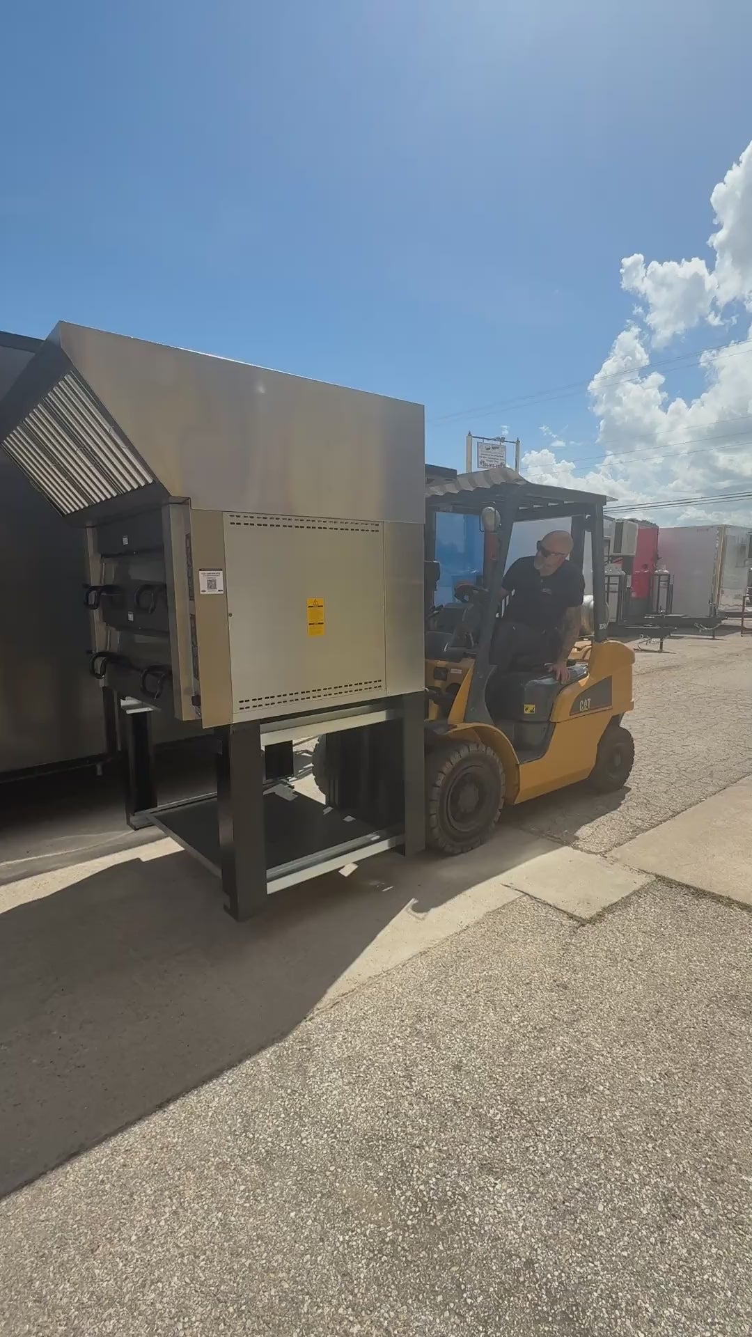 Equipment being set into the 28 FT smoker concession trailer by forklift at the Texas Built shop in Belton