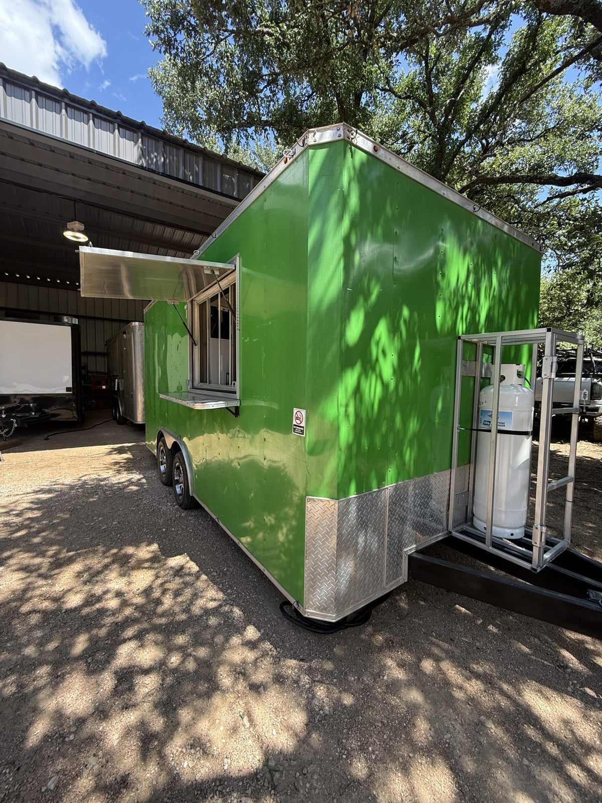 2018 16 FT green concession trailer, exterior three-quarter view with the serving window side facing camera