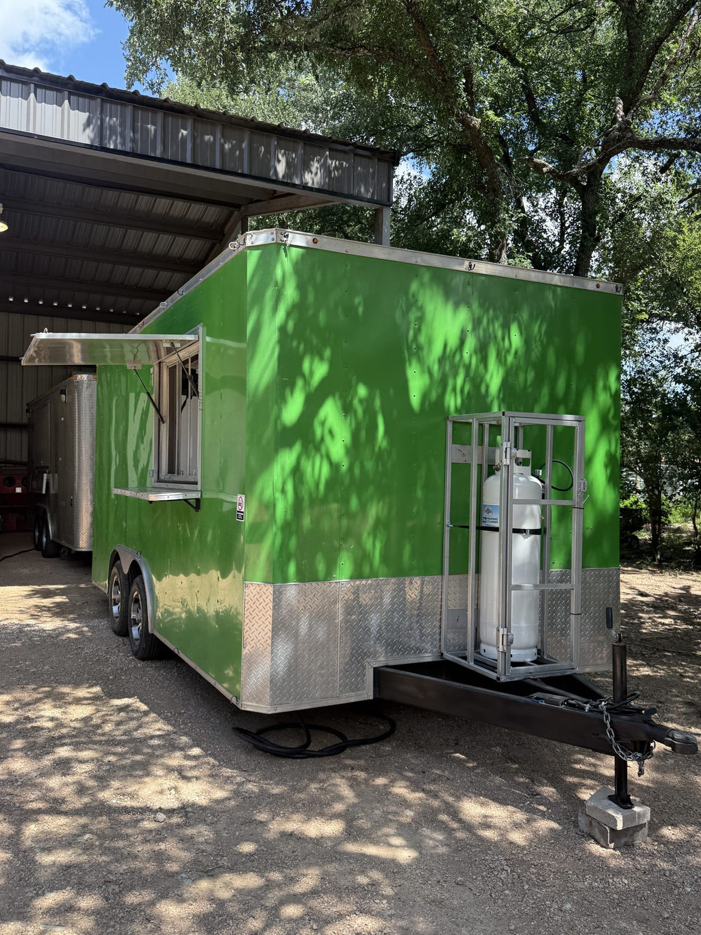 Green concession trailer exterior, front three-quarter view on the lot in Belton, Texas