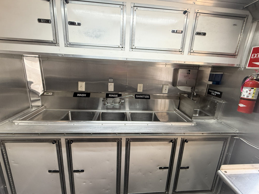 Three compartment sink with overhead cabinets and hand wash sink