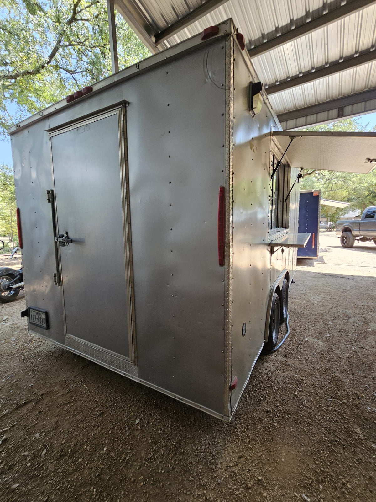 16 FT silver concession trailer, exterior three-quarter view under the shop canopy in Belton, Texas