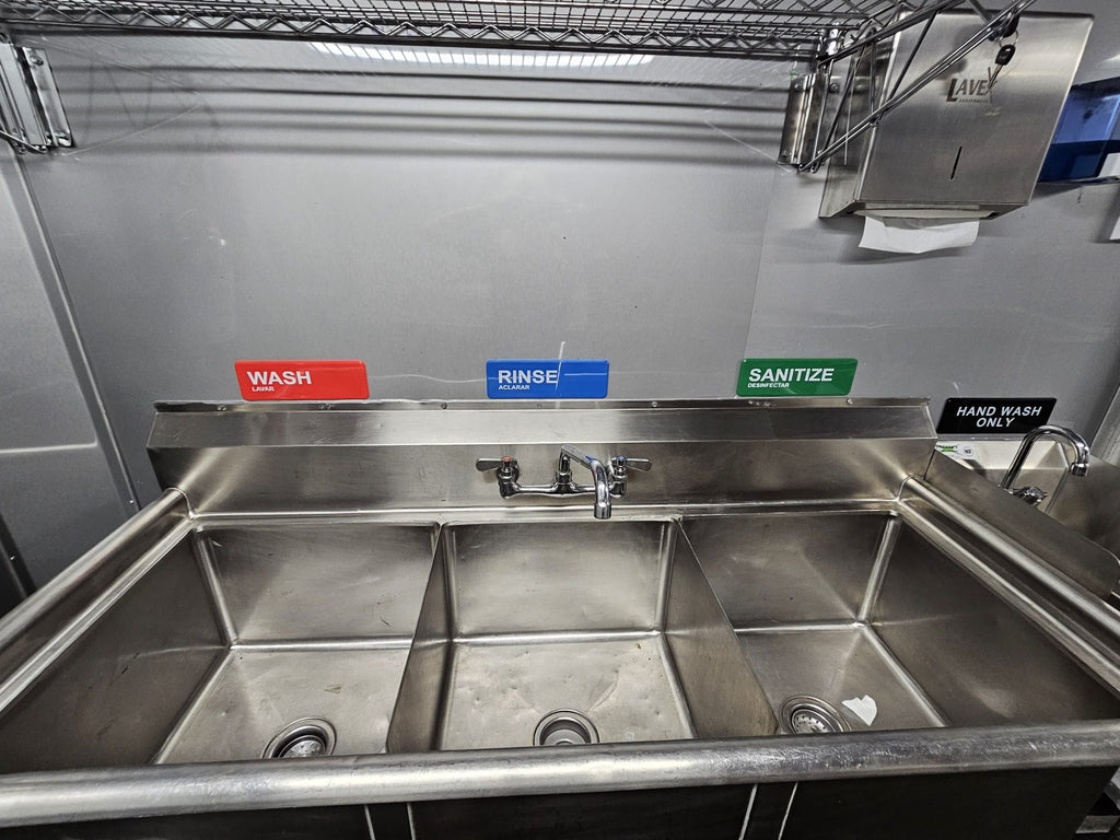 Three compartment sink with wash, rinse and sanitize labels