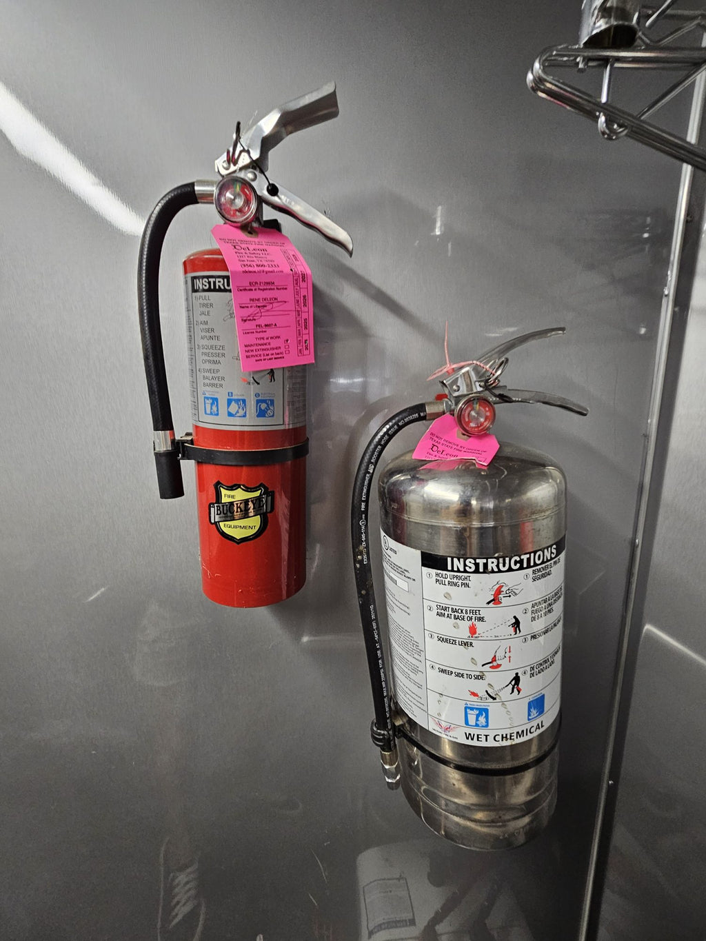Fire extinguisher and suppression canister mounted on the trailer wall
